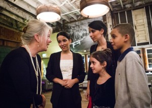 Karen Olsen talks with twin sisters, Sarah, left, and Rebecca, along with Sarah’s daughter Sarah, 7, and Rebecca’s son, Emmanuel, 9, as they thank her for the evening donated to Mary’s Place families at Sodo Park on Saturday. (Lindsey Wasson / The Seattle Times)